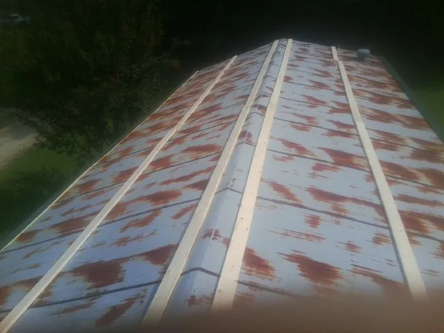 Rusted metal roof panels with new wood purlins before replacement — Storm Damage Roof Repair in Wauregan by Roofing Brothers